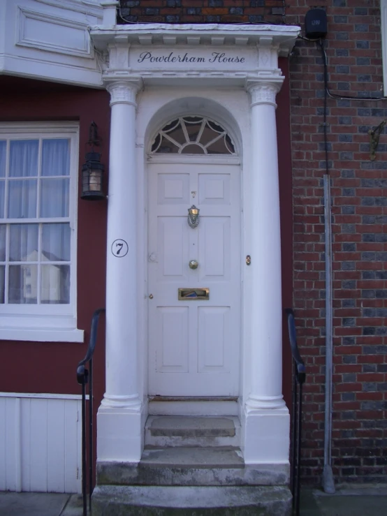 a white door is open on a red building