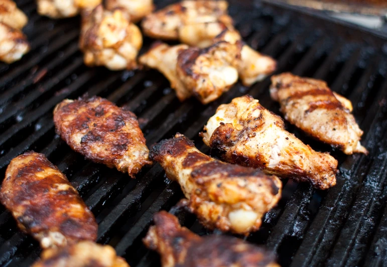 chicken and steak cooking on the grill