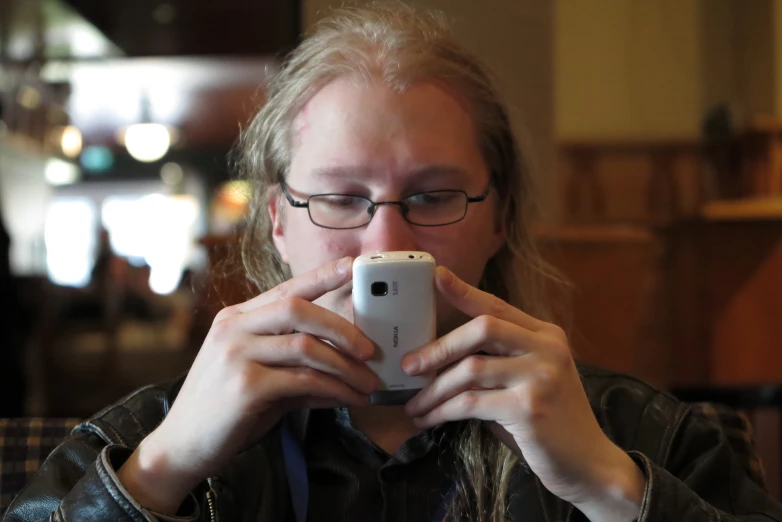 a girl taking a po with a cell phone