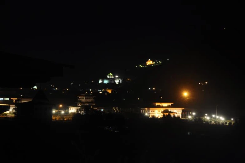 night scene with large city lights in the distance