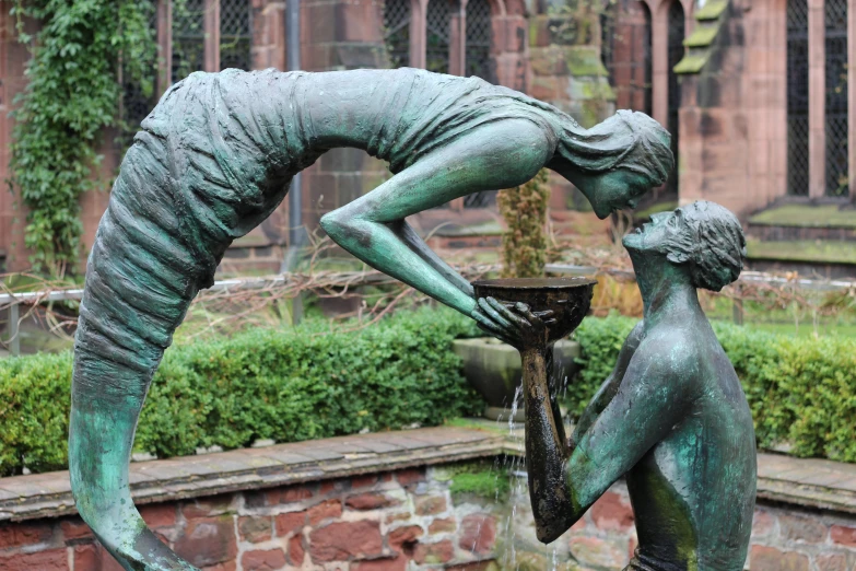 a small fountain in the middle of a garden