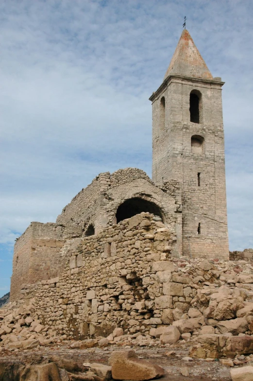 old stone tower with a cross on top