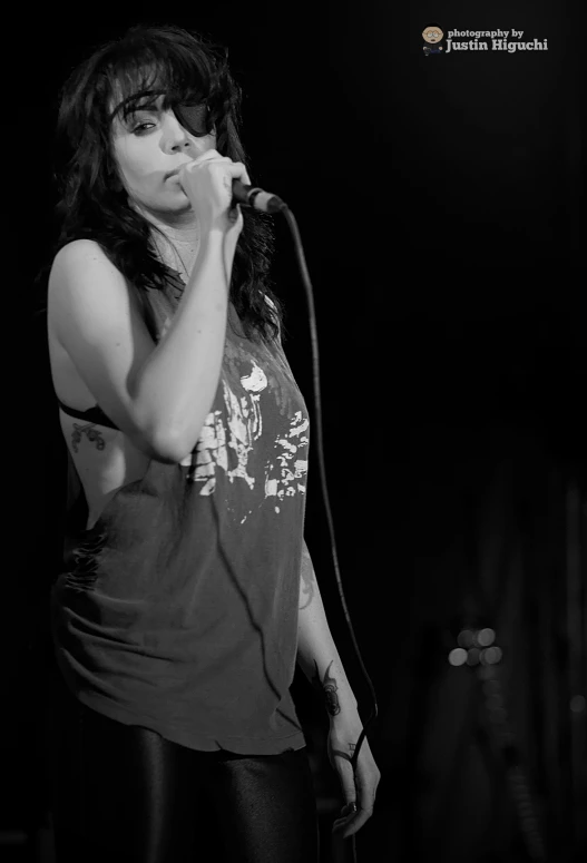 a woman is singing into a microphone