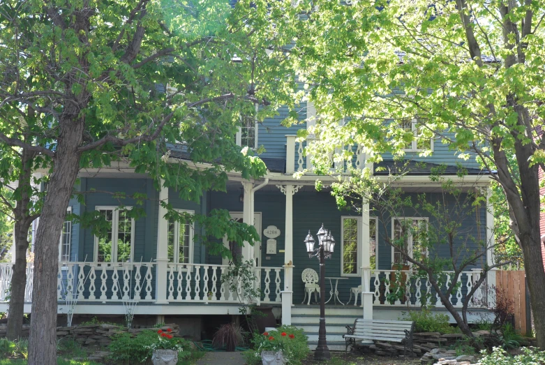 a three story house with lots of columns on the front porch