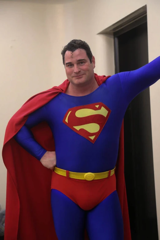 a man dressed as superman posing for a po