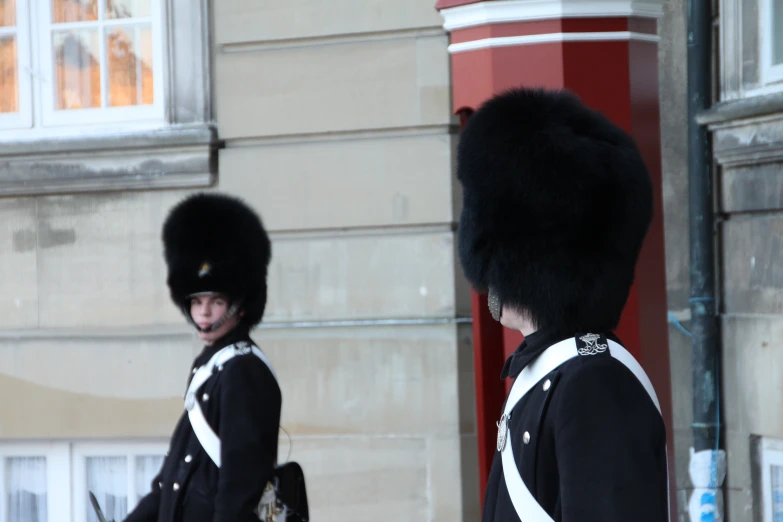 there are two men in uniform on the street