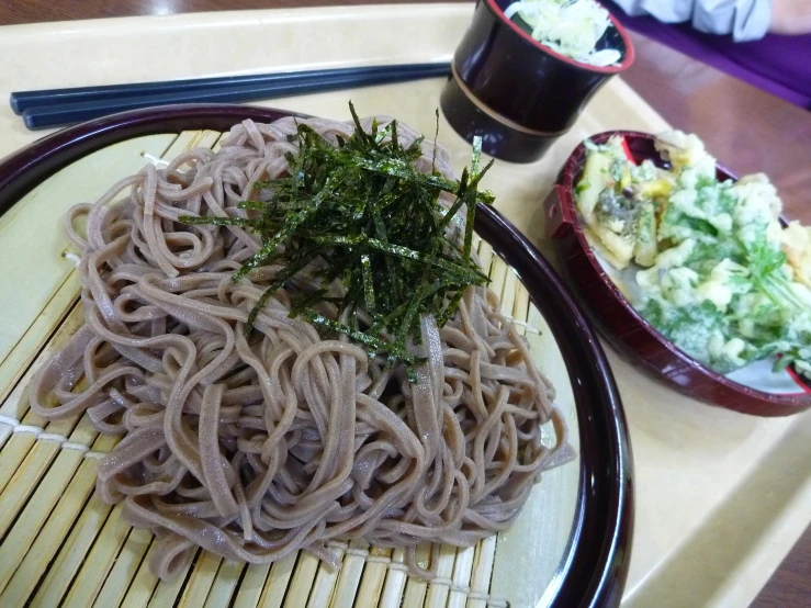 this dish includes noodles, vegetables, and an asian sauce