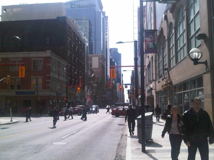 the street is busy with people walking and riding their bikes