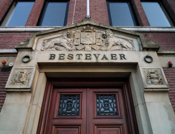 a large brick building with two door and an elaborate entry