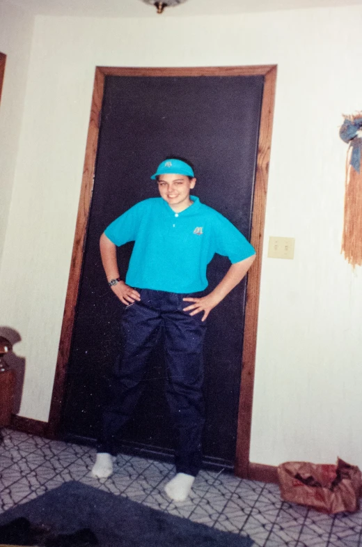 an elderly man standing with his arms on his hips