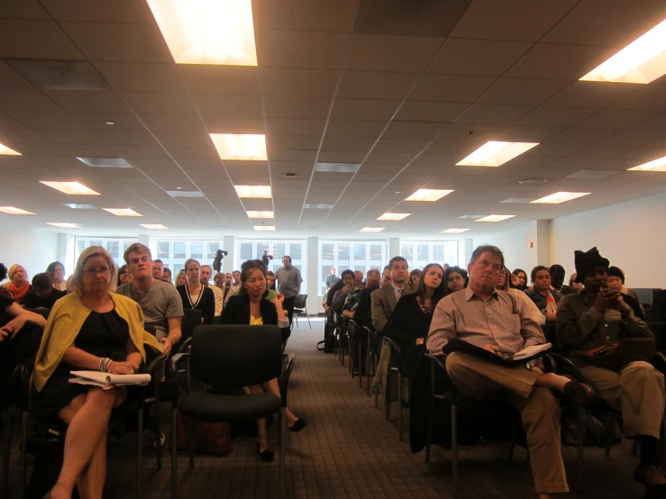 group of people sitting in chairs looking at each other