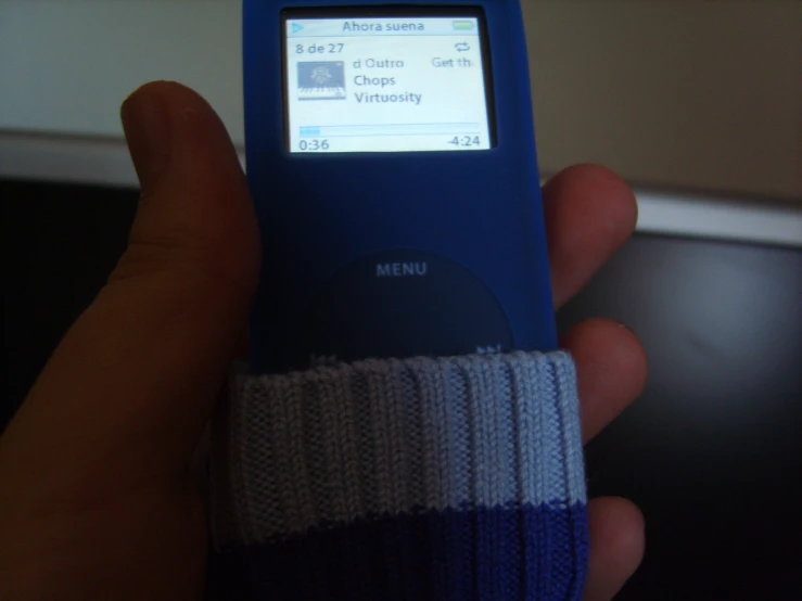 a person is holding an mp3 player in their hand