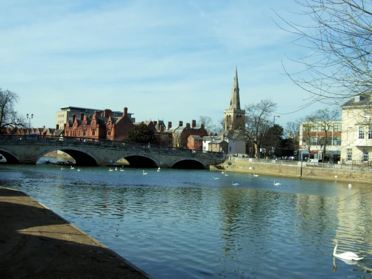 a river runs between two buildings and a bridge