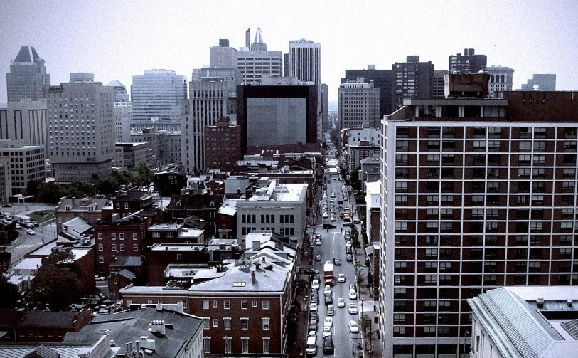 an intersection in front of cityscape with buildings