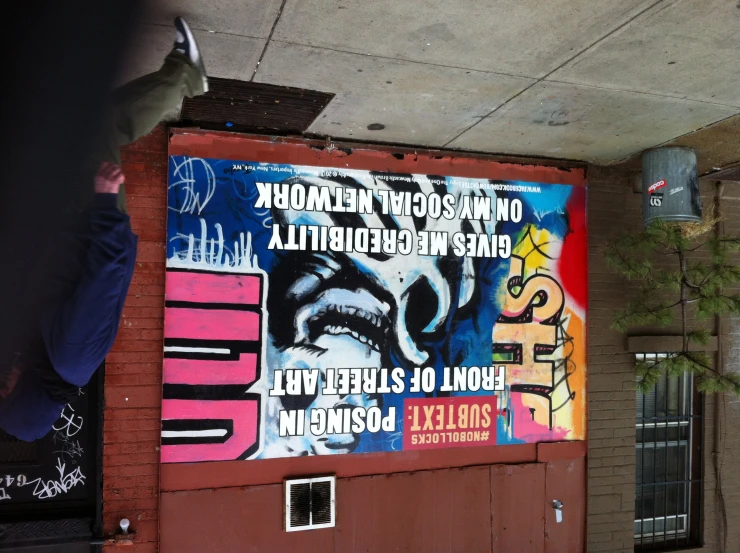 a very large street sign painted on the side of a building