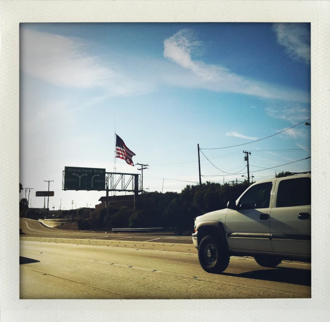 a white pickup truck in an empty road