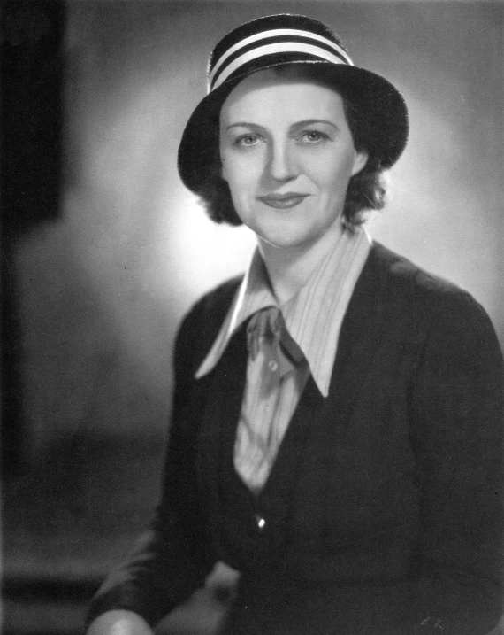 an old picture of a women wearing a hat