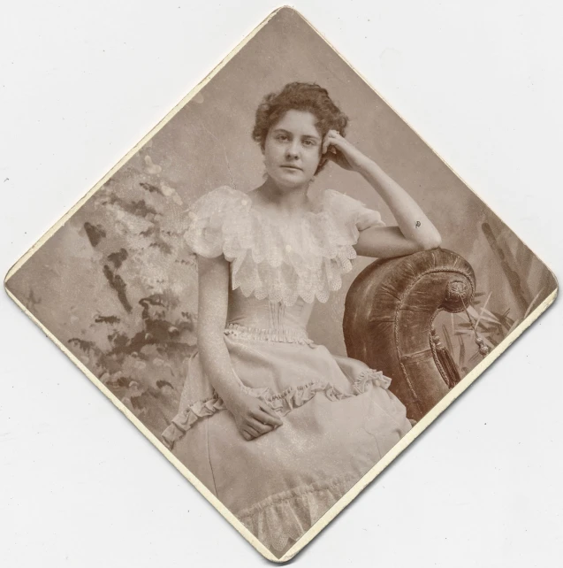 a woman is sitting and posing in an old fashion po