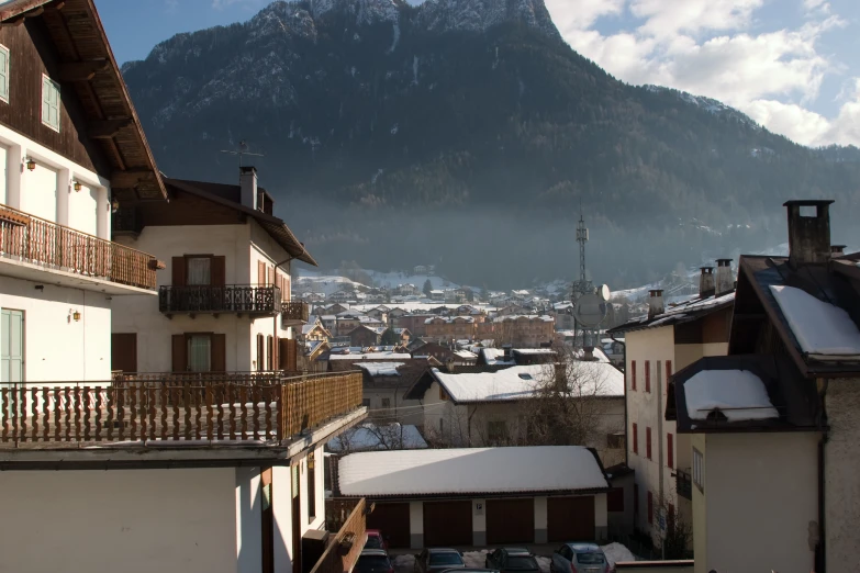 a town with buildings below the mountains