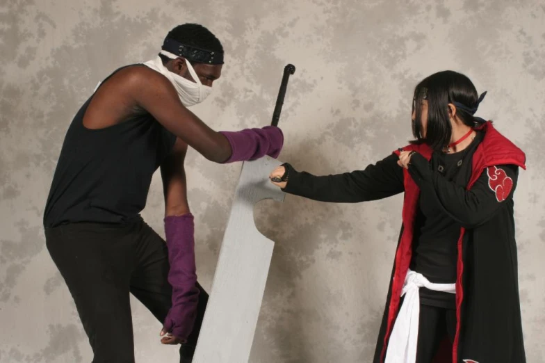 a man helping another woman put on a costume