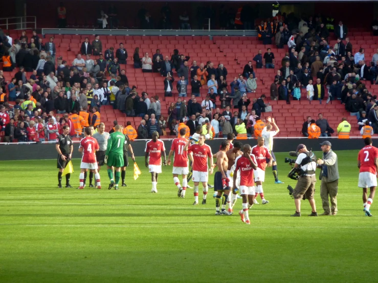 the soccer players are standing in a circle on the field