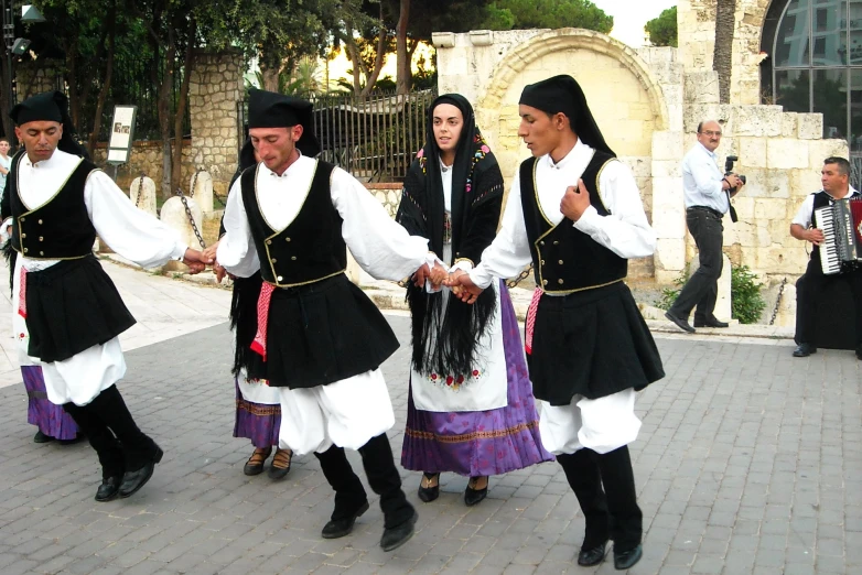several men are dressed in black and white outfits
