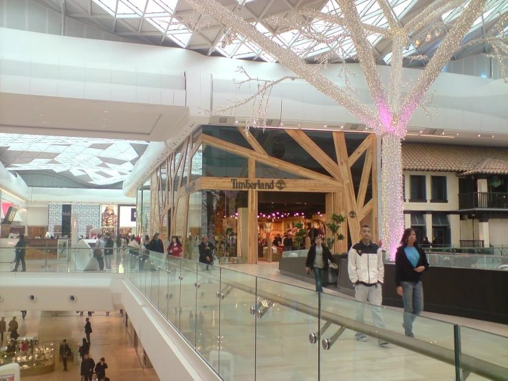 a large atrium with lots of people shopping and walking through it