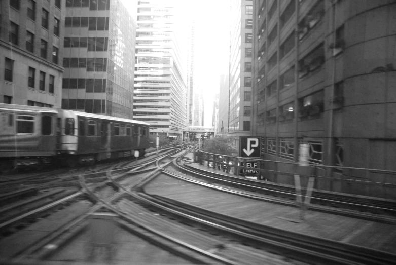 a train moving in front of some buildings