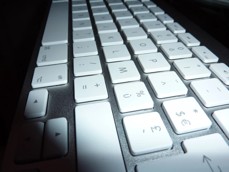 an apple keyboard with the light on