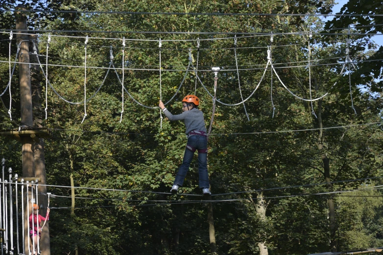 a child on an obstacle course high in the air