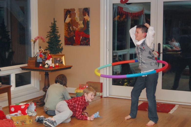 a young man plays with his family while they are in their living room