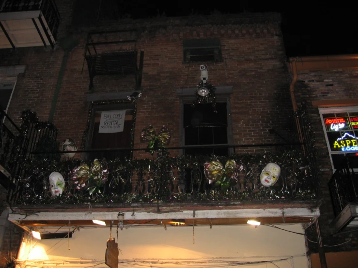 an outside balcony decorated with lights and flowers