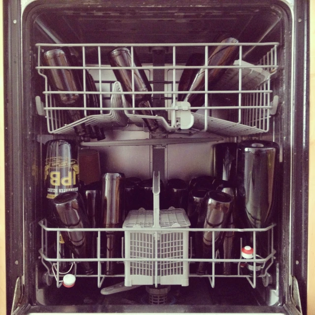 a dishwasher with many different types of utensils inside of it