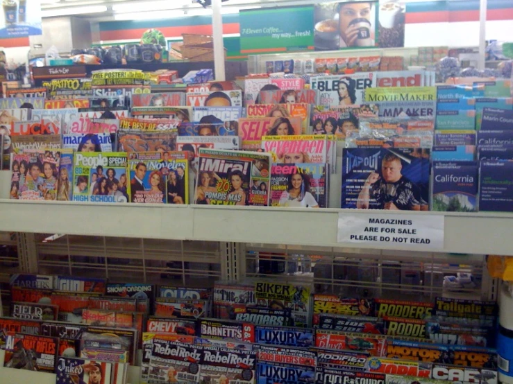magazine shelves are displayed with various kinds of newspapers