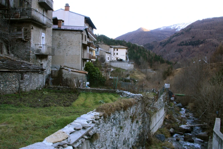 some buildings are near water and some rocks