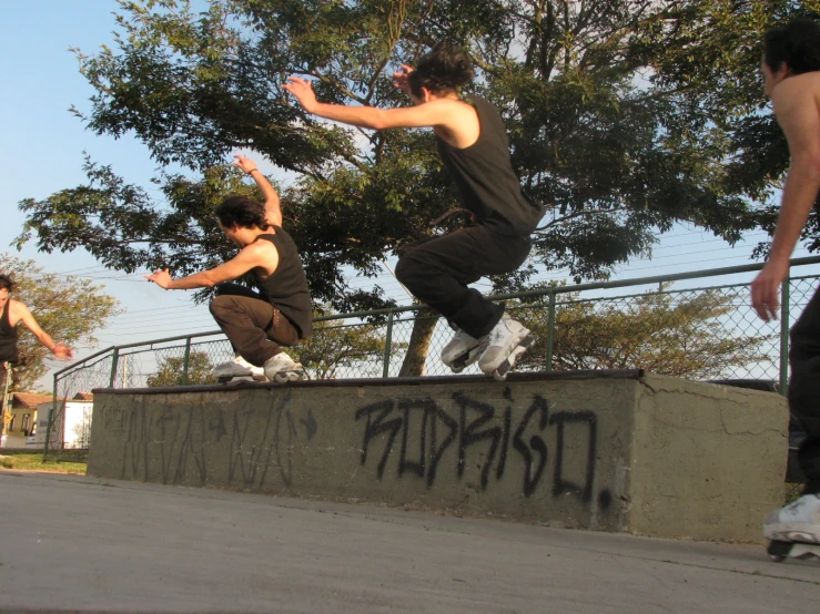 a couple of young men riding skateboards on top of concrete