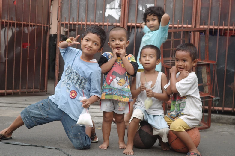 five children sitting and posing for a po