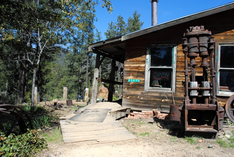 an old house with a very large wheel in front