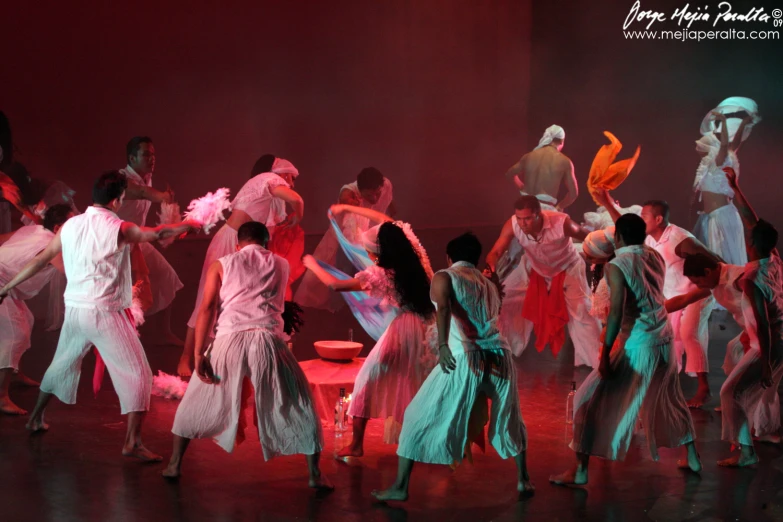 a group of people dancing at night in a dance studio