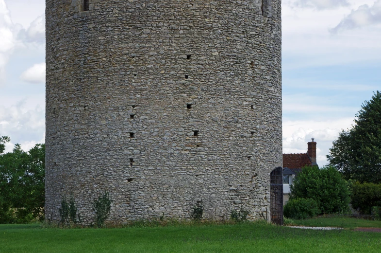 an old stone tower with holes in it