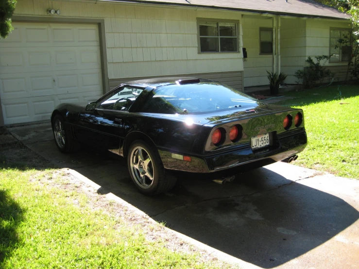 the car is parked in front of a garage