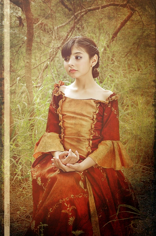 a girl in a red dress sits in a field