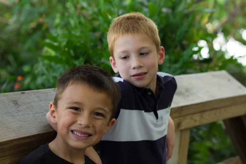 two small boys are smiling and posing for a po