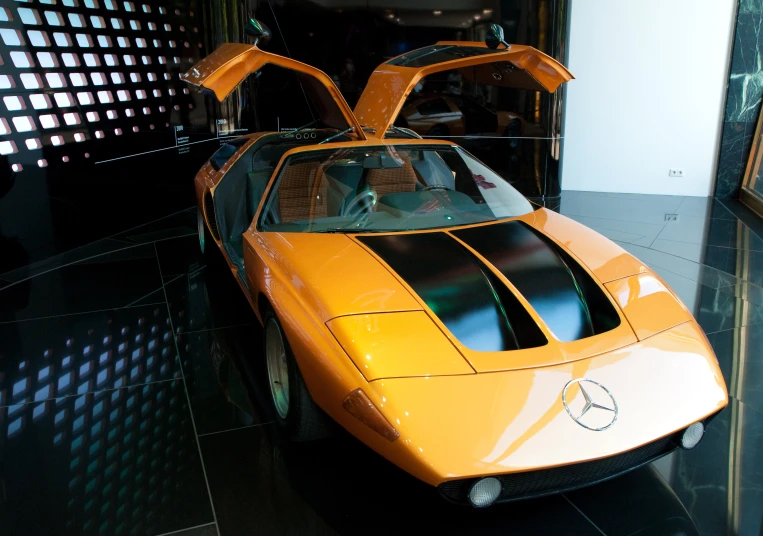 a modern yellow sports car that is displayed