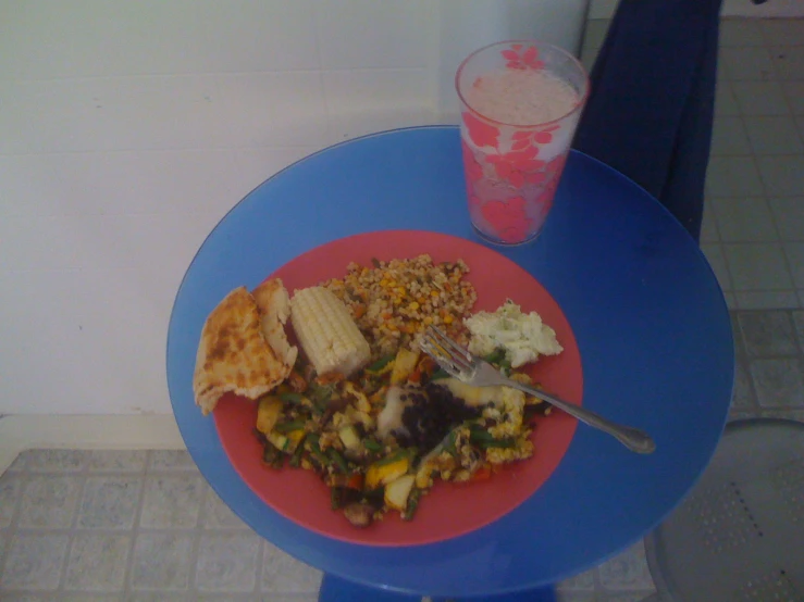 there is a plate with vegetables and bread on the table