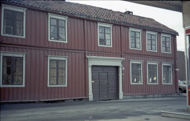 this old po shows a red two story house