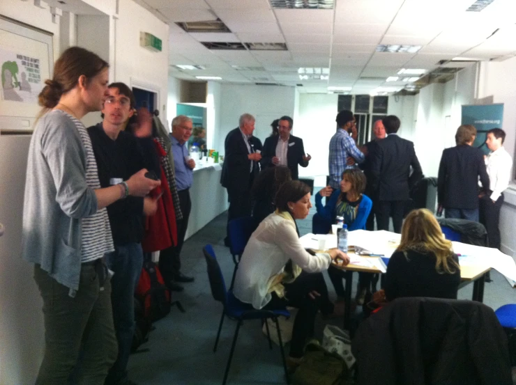 several people in a group gathered in a room