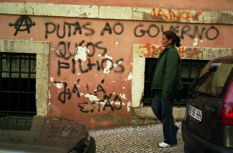 man in front of an area that is marked with graffiti