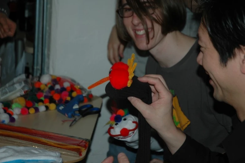 two men who are holding toys and looking at a man