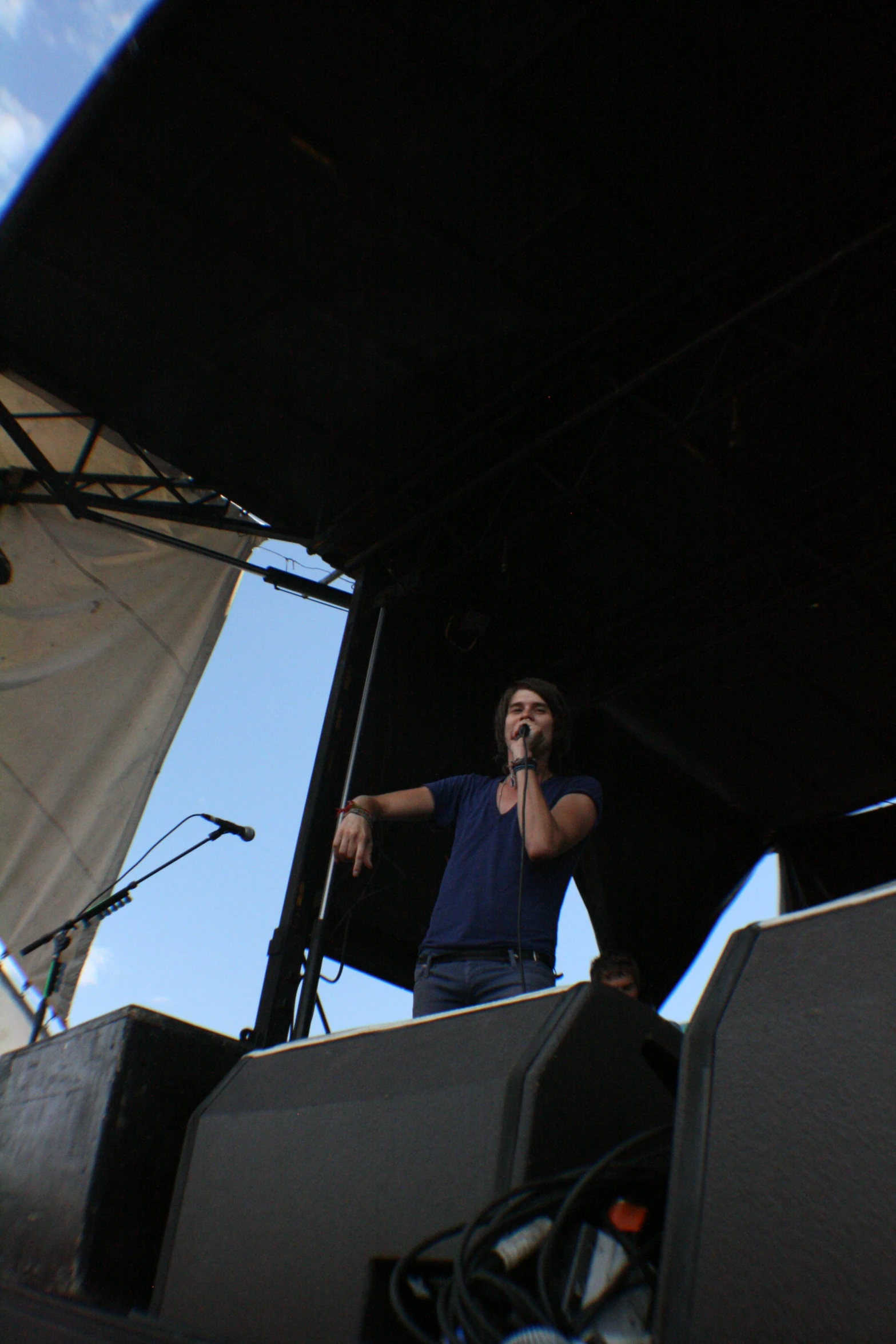 a man on a stage talking on his phone